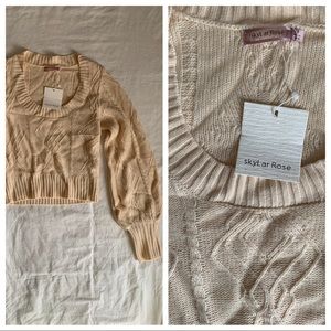 Cropped long sleeve sweater. Tan/pink hue color.